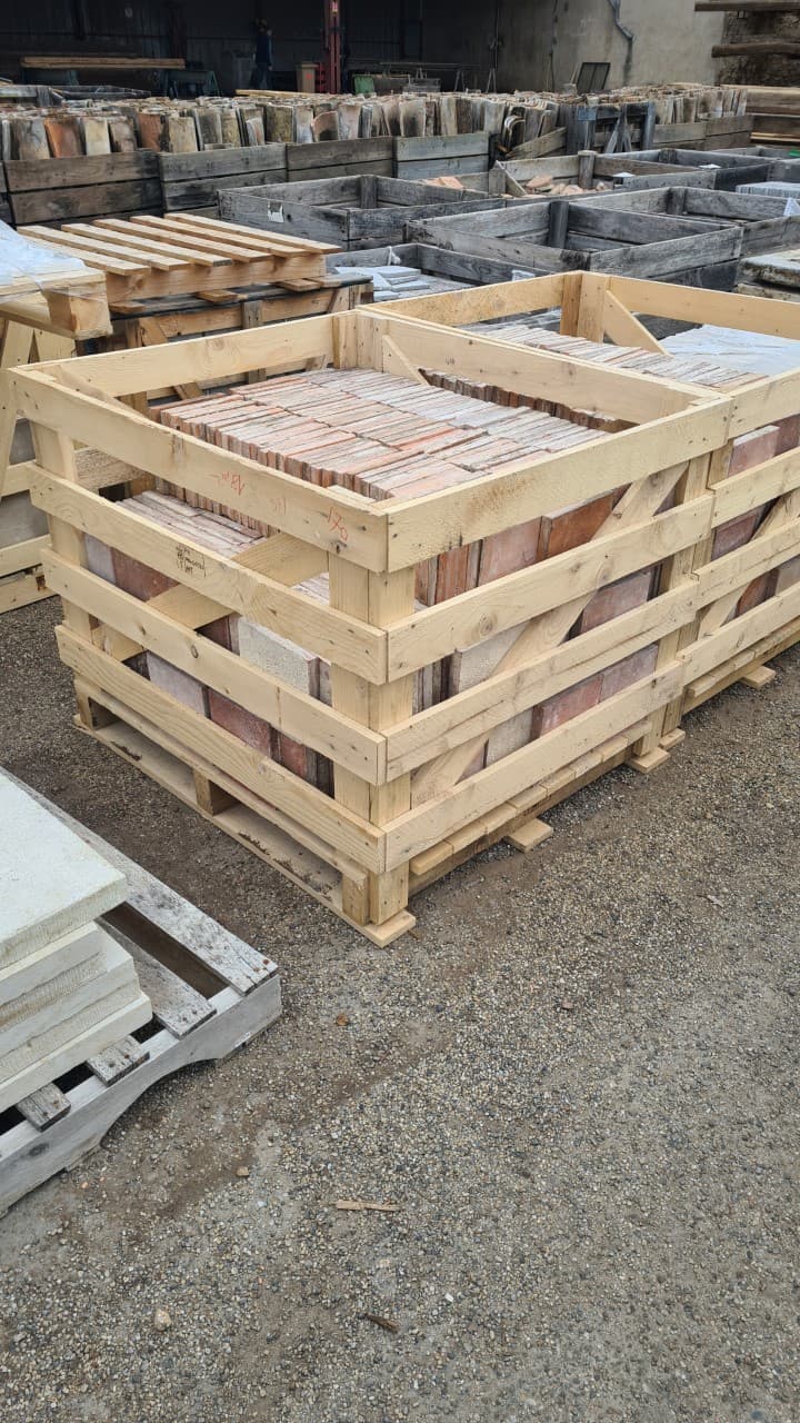 Palox bois chargés de tuiles anciennes chez un marchand de matériaux